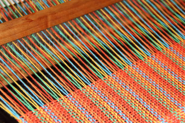 colorful knitted garments and blankets, comb loom, yarns
