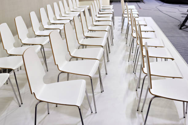 istock Rows of white chairs in presentation room 851994746