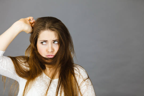 istock Woman having face covered with her brown hair 851996490