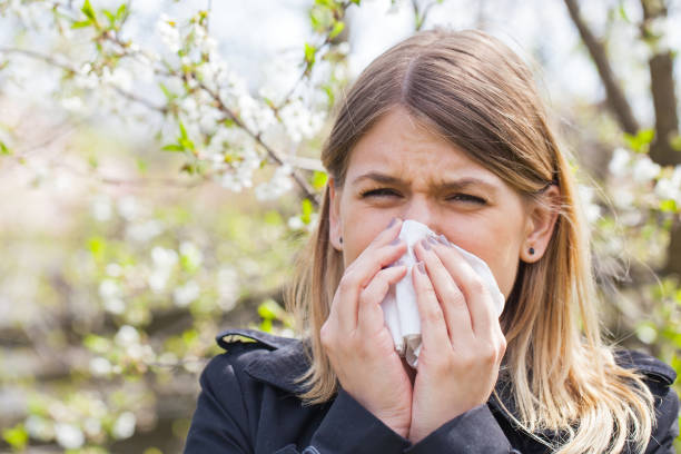 istock Allergic woman sneezing outdoor on springtime 851999854
