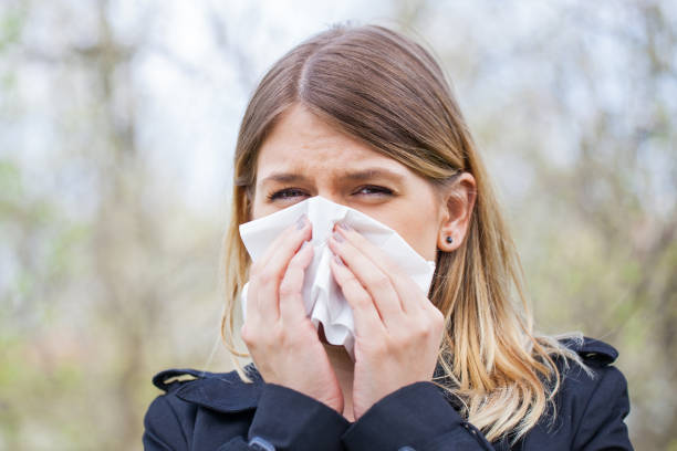 istock Allergic woman sneezing outdoor on springtime 852000178