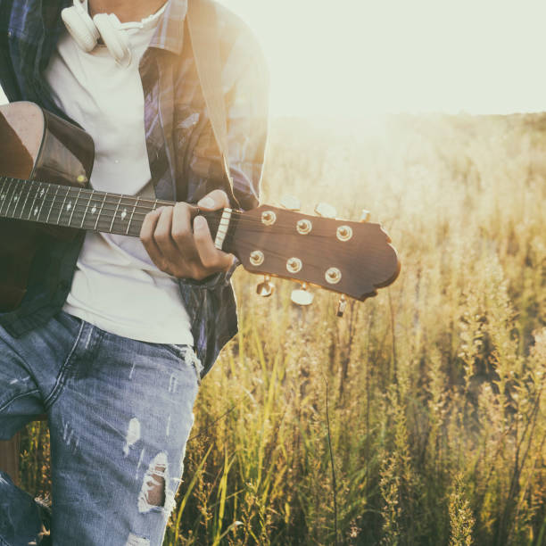 istock closeup of man hands playing guitar in field 852002798