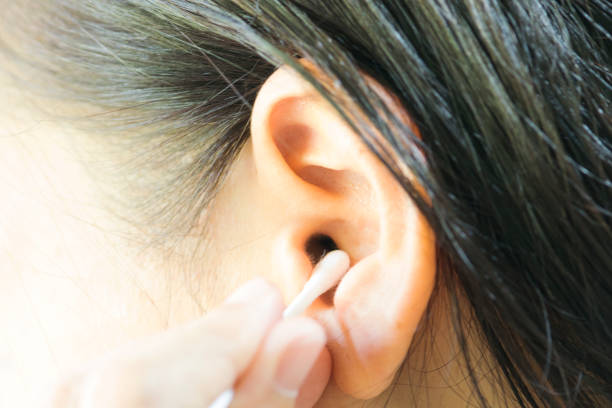 istock Woman cleaning ear with cotton swabs 852006894