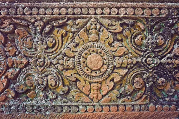 Ancient Cambodian Stone carving on wall of temple complex set in Phanom Rung Historical Park, Buriram province, Thailand