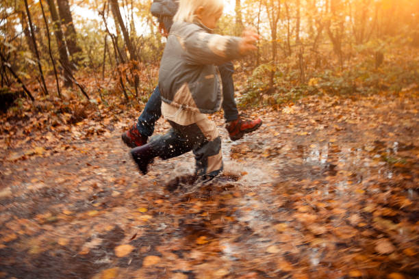 Mother and child in the park in autumn day