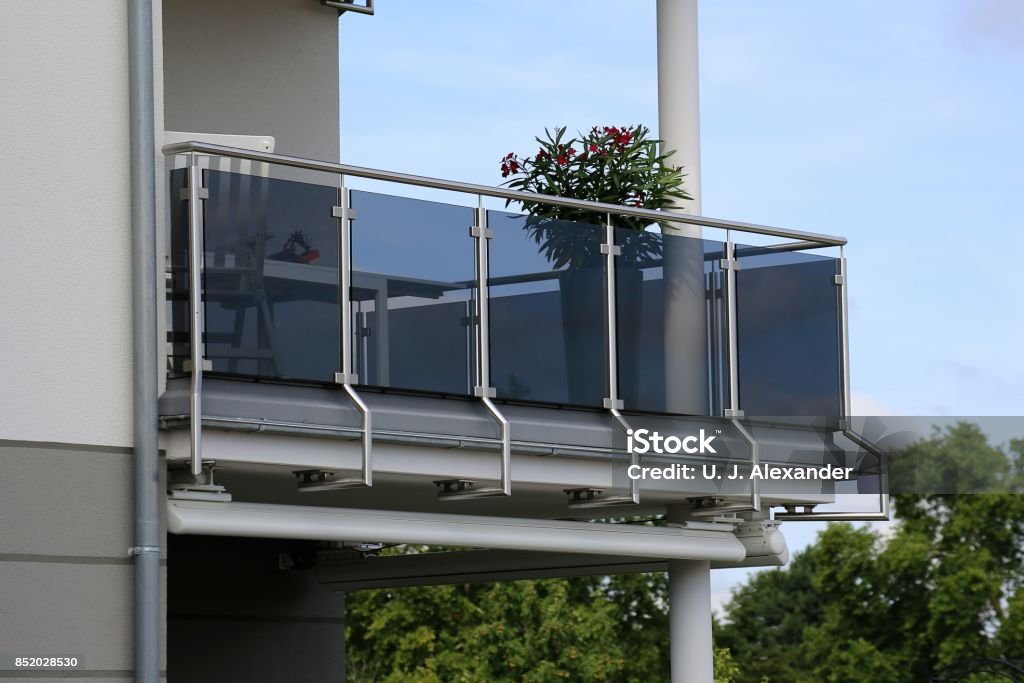 Balcony railing with glass and stainless steel Stainless Steel balcony railing on a residential home Balcony Stock Photo