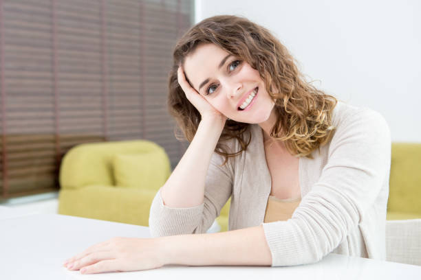 istock Smiling Lovely Woman Sitting at Table at Home 852029014