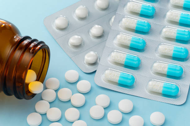 Prescription drugs. Blue capsule medicines and pills. stock photo