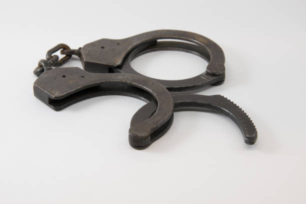 istock Old Police handcuffs isolated on white background 852032114