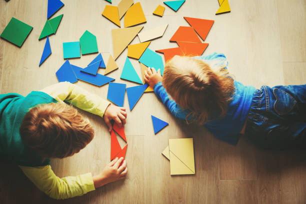 istock kids playing with puzzle, education concept 852032438