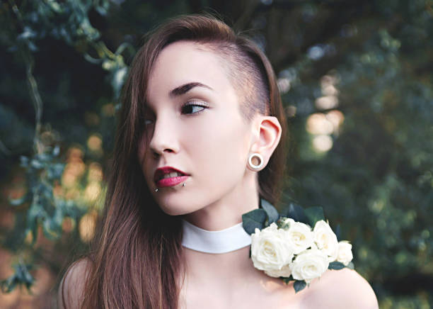 Young woman with roses portrait Young beautiful woman close up portrait in nature half shaved hairstyle stock pictures, royalty-free photos & images