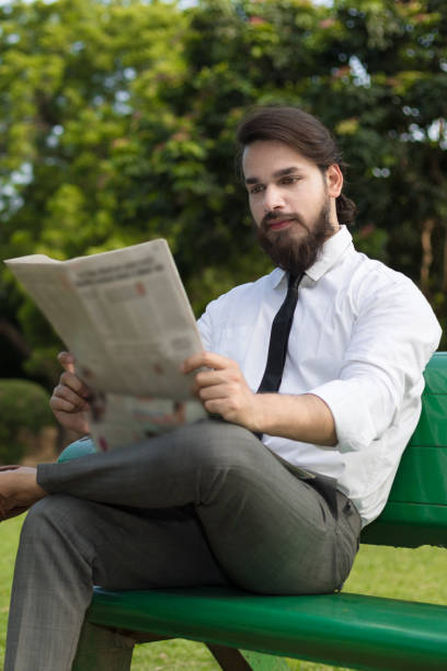istock businessman reading newspaper 852035370
