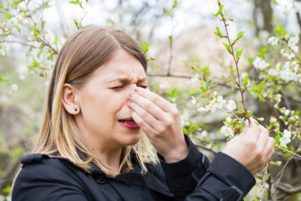 istock Allergic woman sneezing outdoor on springtime 852036270