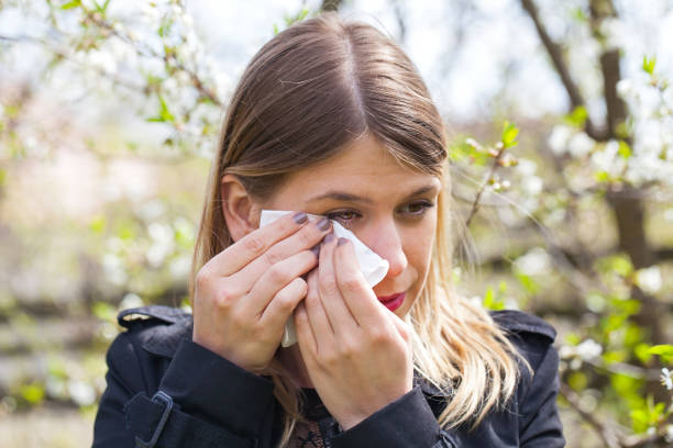 istock Allergic woman sneezing outdoor on springtime 852036746