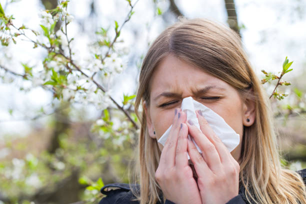 istock Allergic woman sneezing outdoor on springtime 852036826
