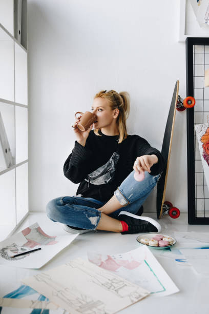 fashion designer with cup and macarons