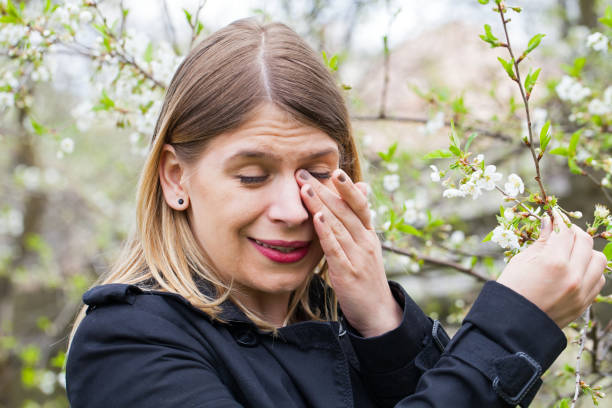 istock Allergic woman sneezing outdoor on springtime 852037346