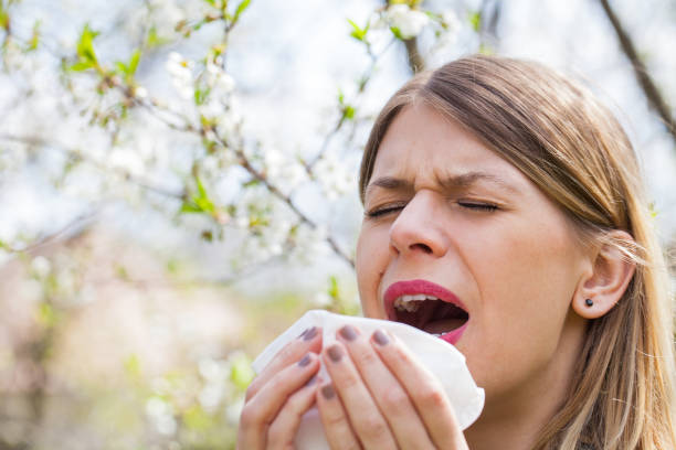istock Allergic woman sneezing outdoor on springtime 852037656