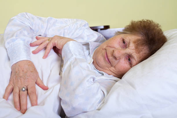 istock Sick elderly woman lying in bed 852037712