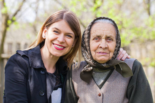 istock Sick elderly woman with her caretaker outdoor 852038054