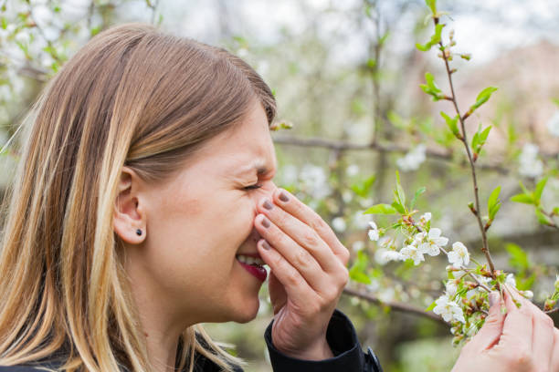 istock Allergic woman sneezing outdoor on springtime 852040266