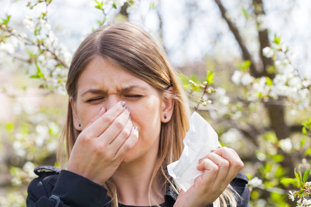 istock Allergic woman sneezing outdoor on springtime 852040344