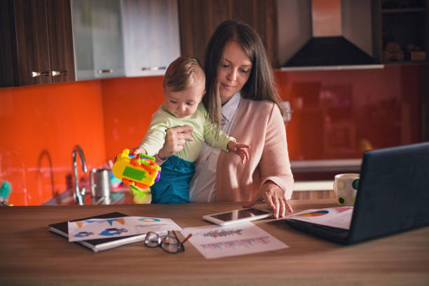 istock Urban young mom balancing work and family 852044266