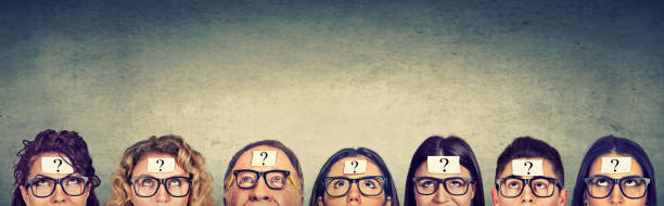 istock Multiethnic group of thinking people in glasses with question mark looking up 852049398