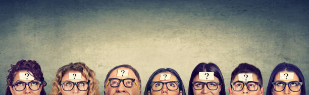 Multiethnic group of thinking people in glasses with question mark looking up Multiethnic group of thinking people in glasses with question mark looking up myopia photos stock pictures, royalty-free photos & images