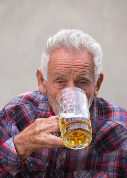 istock Senior man with beer bottle and mug 852058754