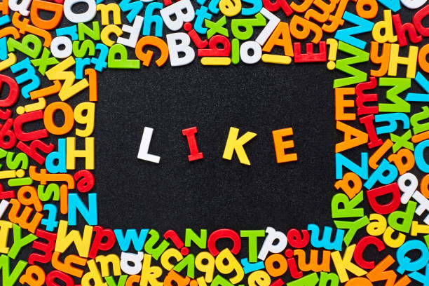 istock Overhead view of like text amidst colorful alphabets on blackboard 852059810