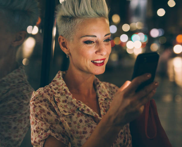 istock Elegant woman texting at night 852060084