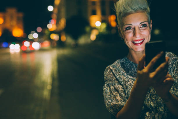 istock Elegant woman texting at night 852060100