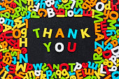 Overhead view of thank you text amidst colorful alphabets