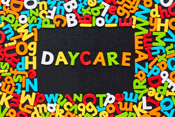 istock Overhead view of daycare text amidst colorful alphabets on blackboard 852062914
