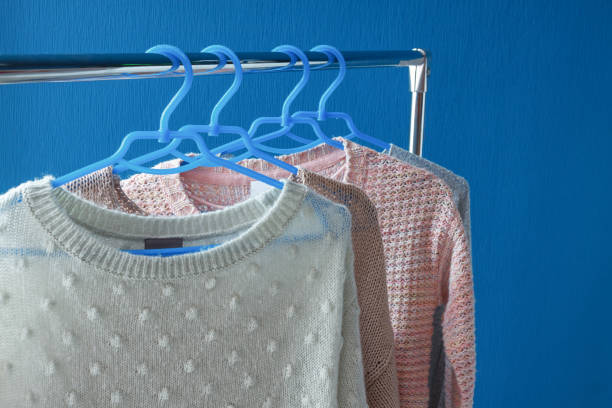 istock Warm woolen sweaters hanging on hangers 852063180