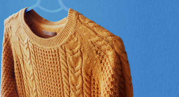 istock Warm woolen sweater hanging on hanger 852063212