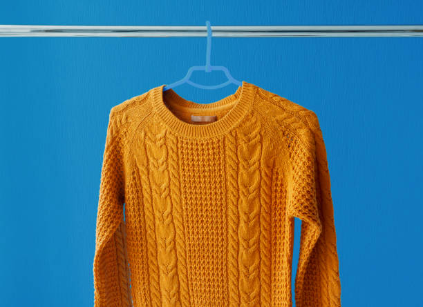 istock Warm woolen sweater hanging on hanger 852063216