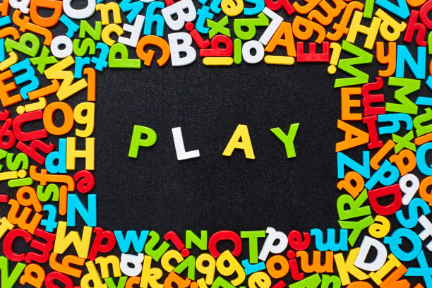 istock Overhead view of play text amidst colorful alphabets on blackboard 852063520