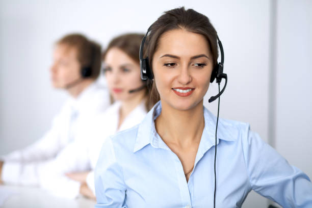 istock Call center. Focus on beautiful woman in headset 852064494