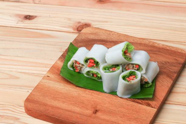 istock spring roll and vegetable  on banana leaf on Chopping Wood, Select focus with shallow depth of field. 852067196