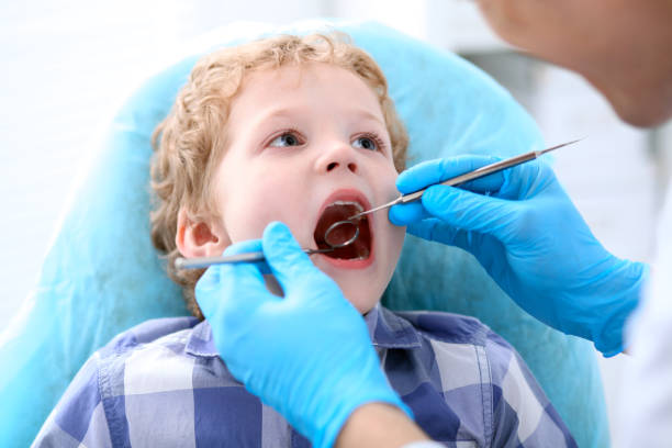 istock Close up of boy having his teeth examined by a dentist 852067242