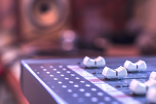 Close-up sound control buttons for professional sound engineers.