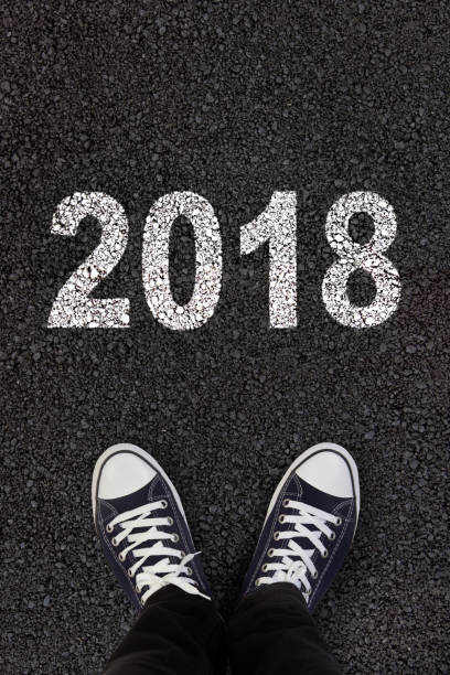 istock 2018 written on fresh asphalt with man's feet 852073400