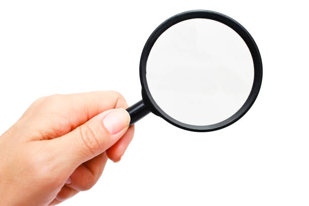 istock Hand holding magnifying glass isolated on white background 852074382