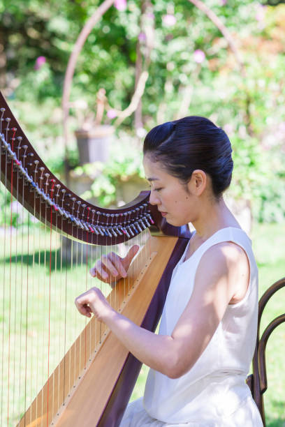 istock Woman Playing Harp Outdoors 852079140