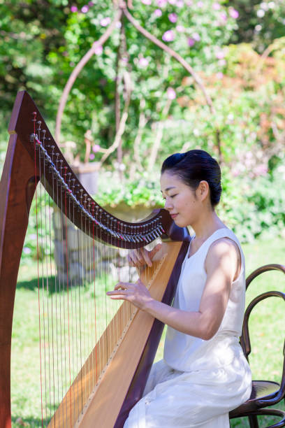 istock Woman Playing Harp Outdoors 852079202