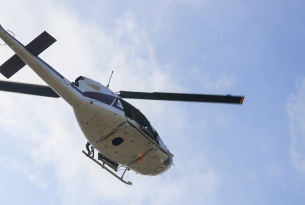 istock helicopter moving in blue sky with blur propeller 852082850