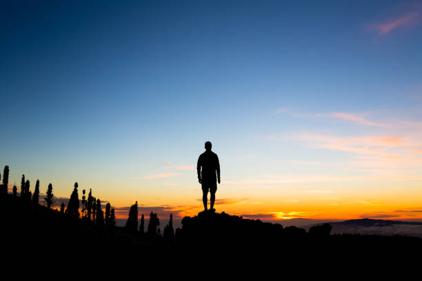 istock Man celebrating sunset looking at view in mountains 852084488