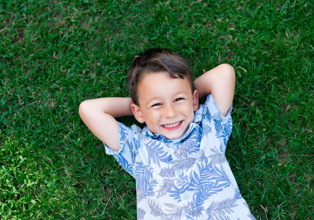 istock Happy child lies on the grass 852084532